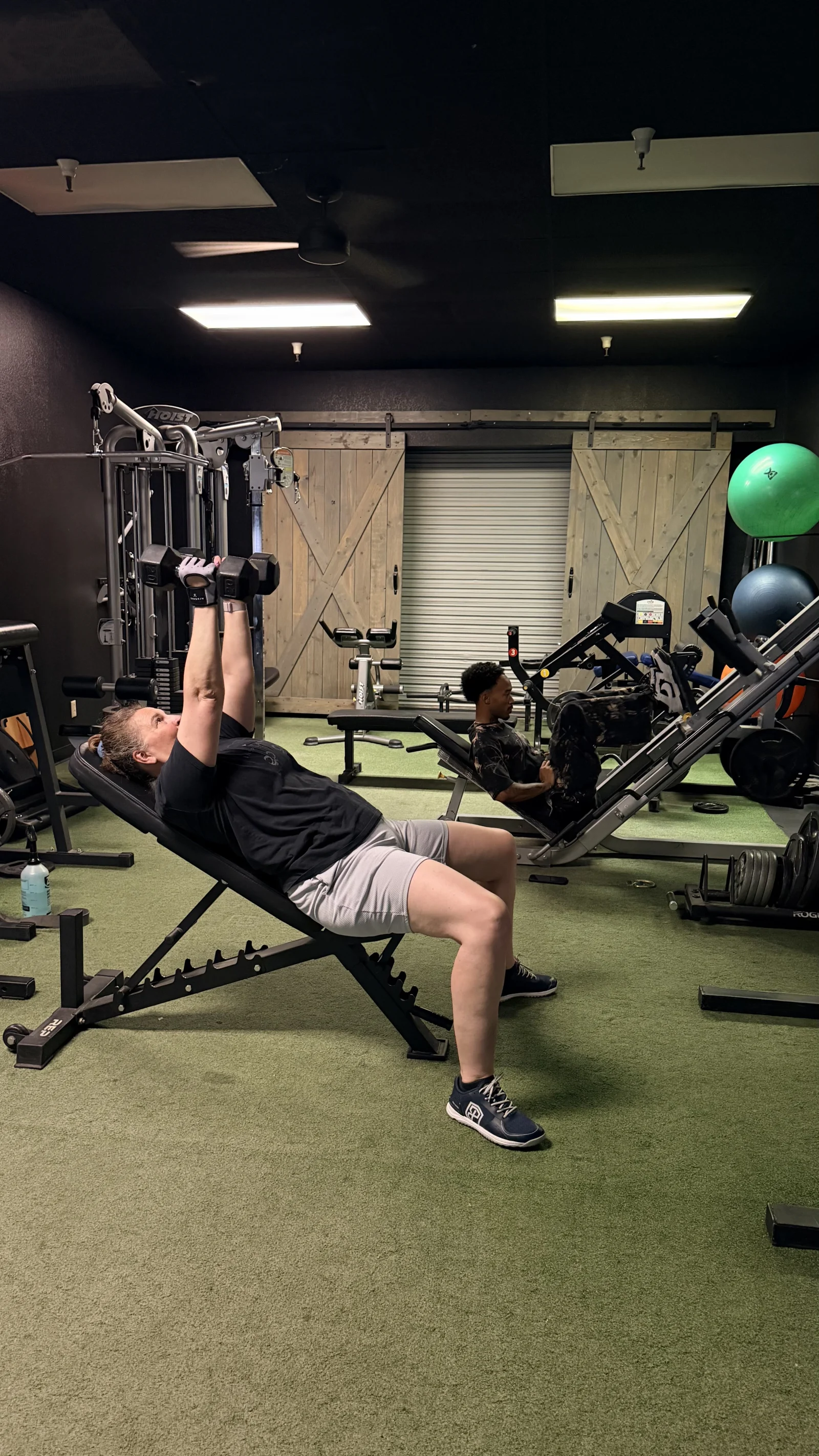 Member training on equipment at The Gym of Tucson open gym