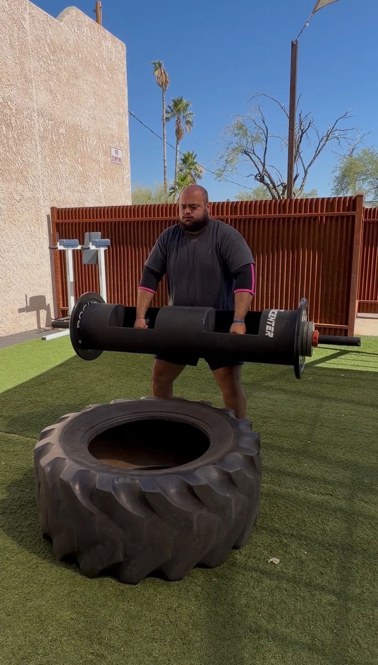 Member deadlifting in the outdoor training area at The Gym of Tucson